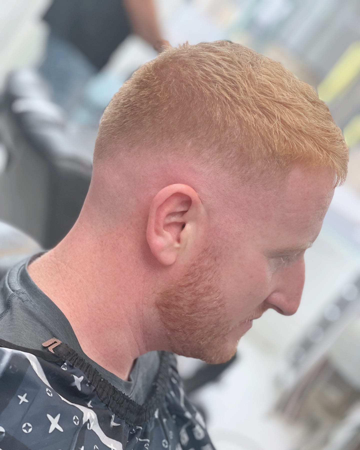 A short blond crop with a carefully blended fade
