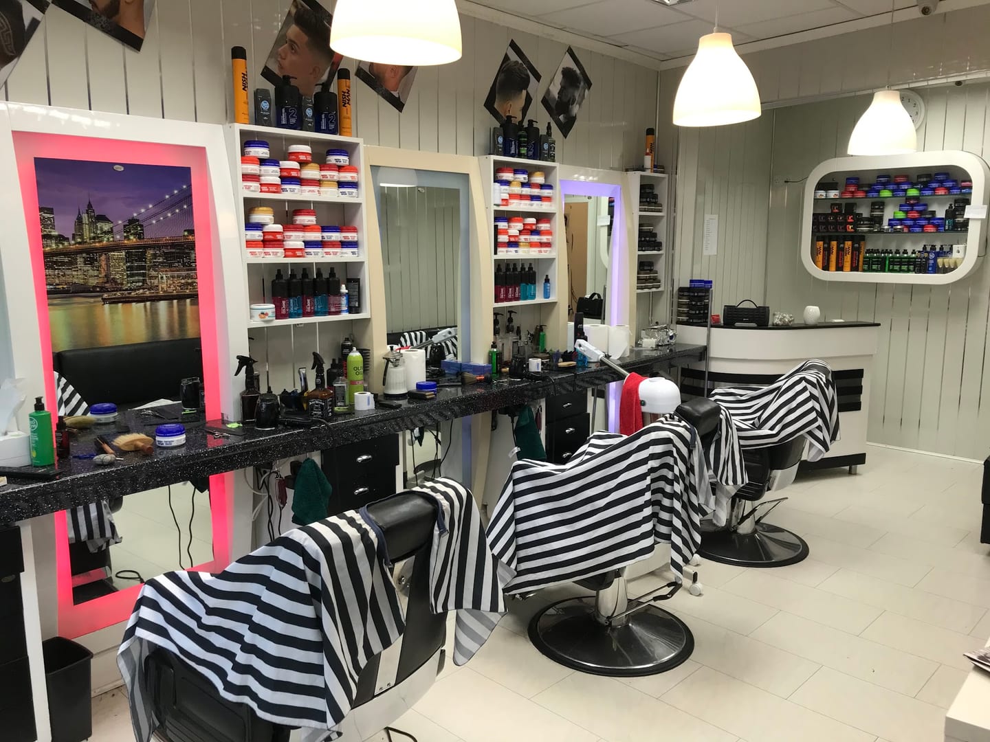 The bright Horsforth shop with mirrors and three barber chairs